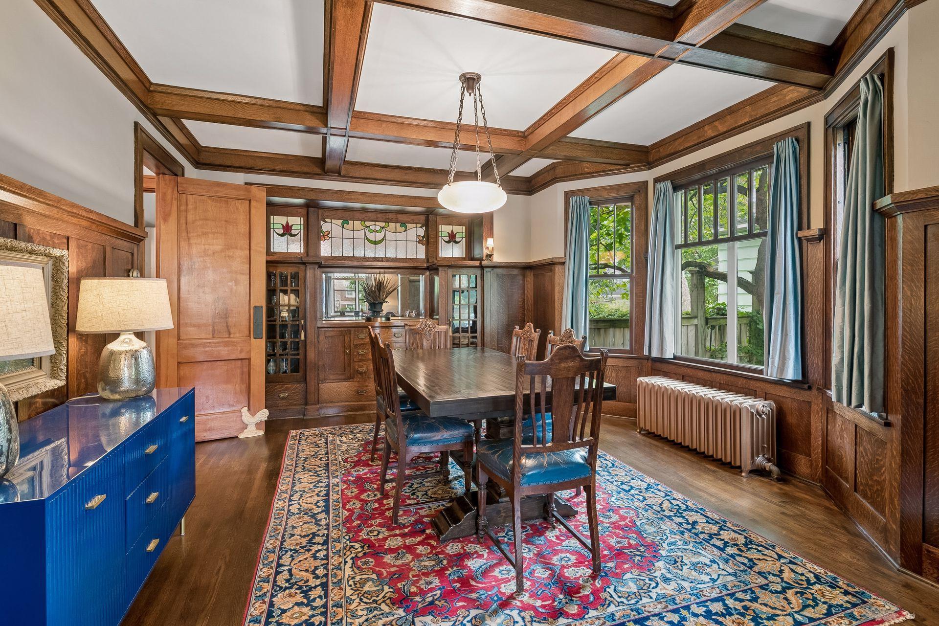 The dining room showcases the home's exceptional box-beam ceiling.