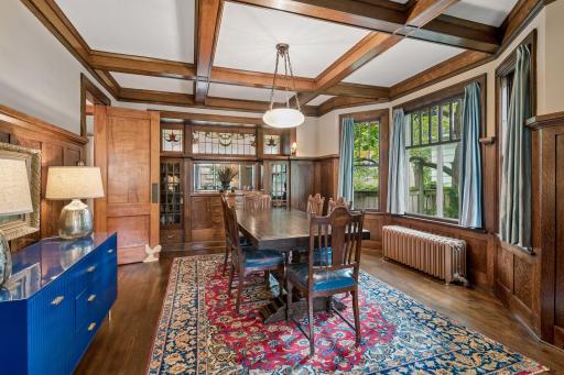 The dining room showcases the home's exceptional box-beam ceiling.