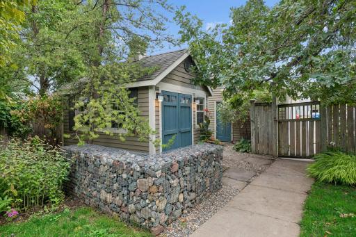 A gabion design element at the corner of the custom built garden shed.