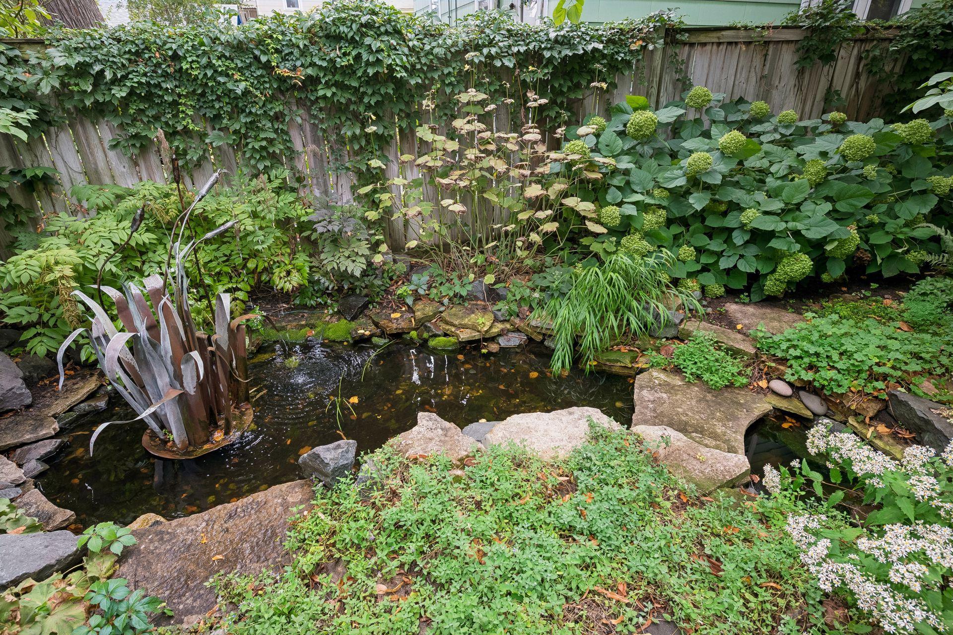 A large pond and water feature add a peaceful element to the backyard.