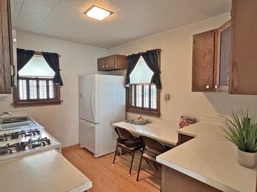 Kitchen with eating area, numerous cabinets & 2 windows