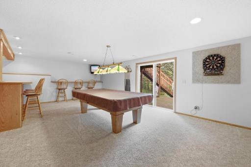 The basement features even more entertaining space with a billiards room, wet bar, and another sliding glass door leading to the lower deck!