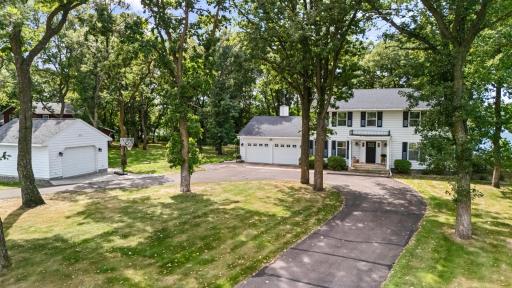 Stunning 2 story with attached and detached garage with mature oaks and horse-shoe driveway
