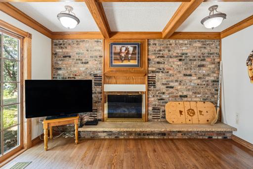 Brick fireplace with gas insert for cozy nights and chilly mornings