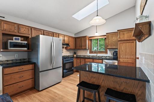 Spacious kitchen with granite countertops and new whirlpool fridge!