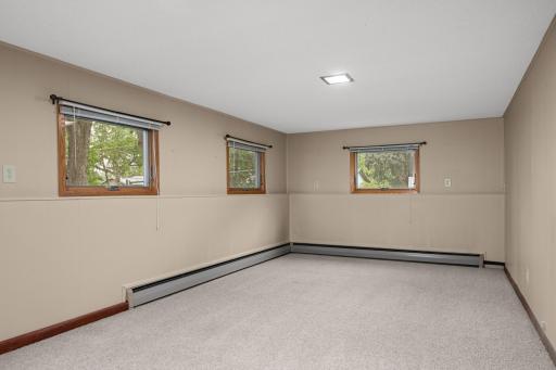 Large Lower Level Family Room with three lookout windows and plenty of space for TV, games or a play area.