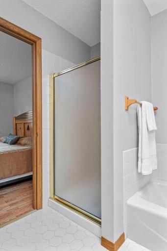Seperate shower and bath tub! Neutral tiled flooring in the upper bathroom!