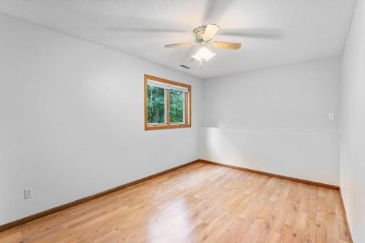 Spacious lower 3rd bedroom with look out windows! Clean, neutral palette and standout flooring!
