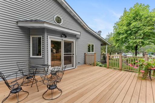 The spacious dining area walks out to an oversized deck overlooking the beautiful tree-lined backyard which is perfectly set up for relaxing, entertaining, and enjoying the outdoors.