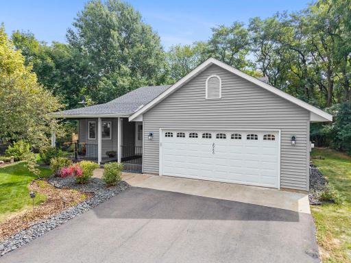 Charming Three Level Split with standout curb appeal and tree-lined backyard.