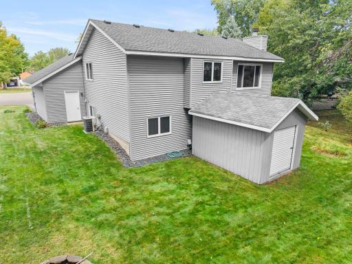 A storage shed provides additional space for lawn equipment, bikes, and outdoor gear.