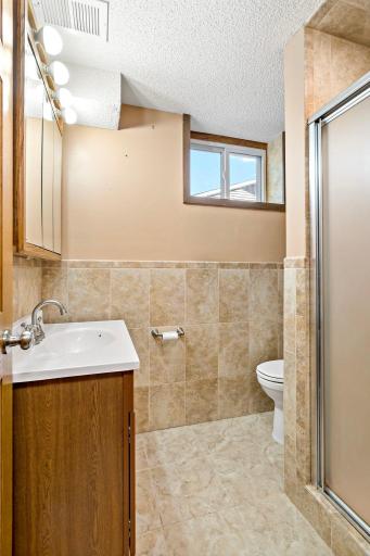 A tiled lower-level 2nd bath with shower.