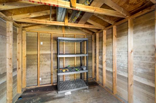 Inside the shed: shelving and electricity for storage or a workshop.
