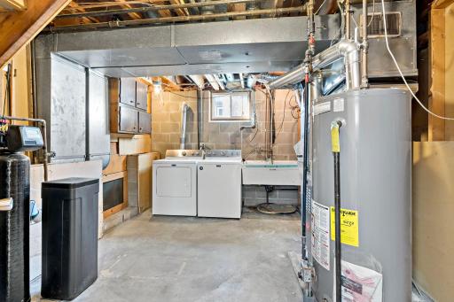 The utility room offers laundry, a laundry sink, and extra storage.