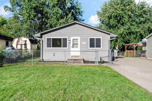 A fenced front yard and a wide lawn out front.