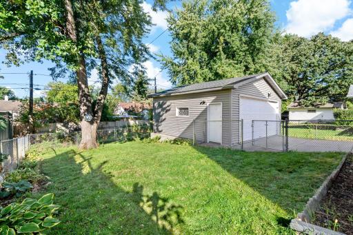 The fully fenced backyard is ready for play, gardening, and pets.