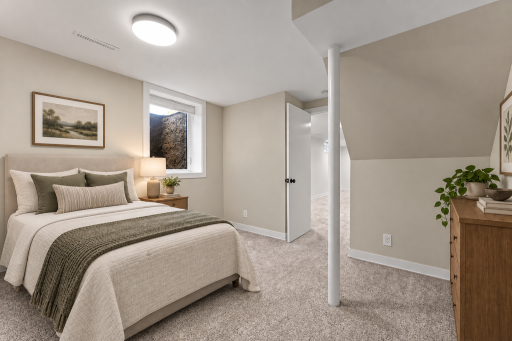 Virtually staged lower level bedroom. Features an egress window and a spacious walk-in closet.
