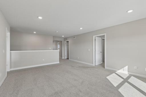 Long view of the upper level loft area. There is an office nook that was built out in the far corner. Complete with fiber optic outlet.