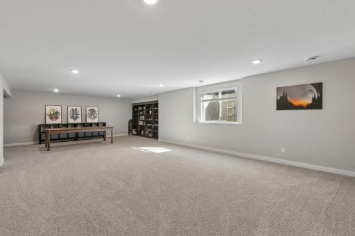 Lower level entertainment room with gaming nook.