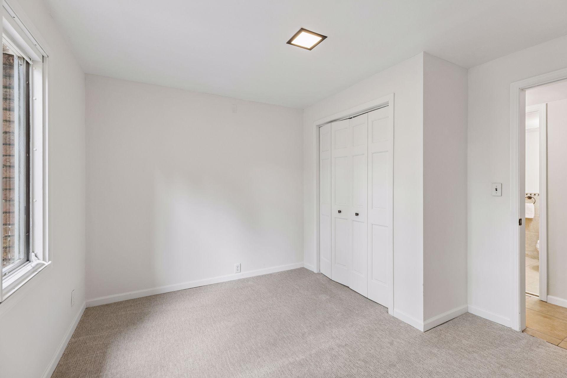 Bedroom 3 in lower level, freshly painted with new carpet