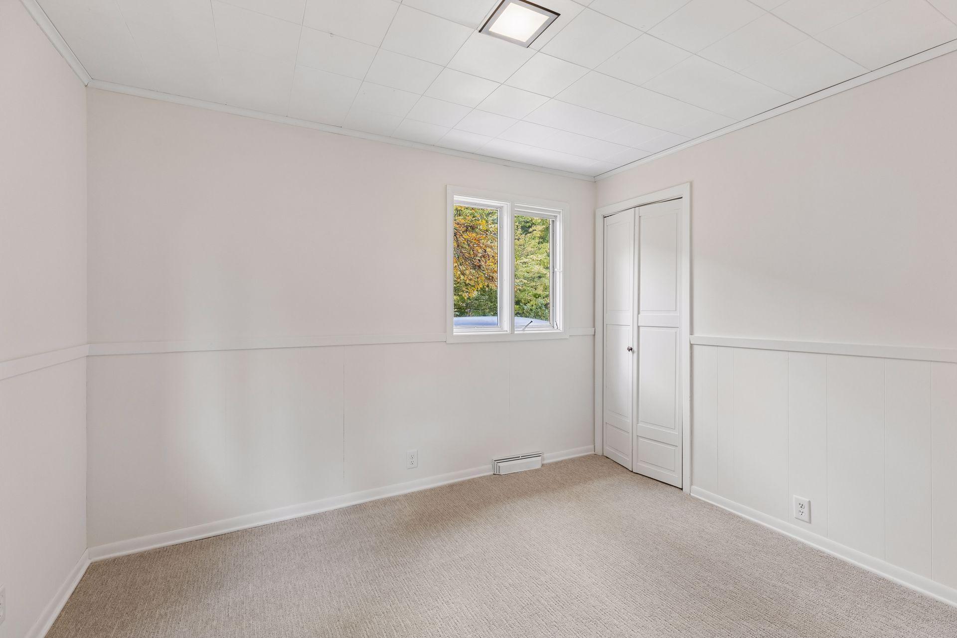 Bedroom 4 in lower level, freshly painted with new carpet