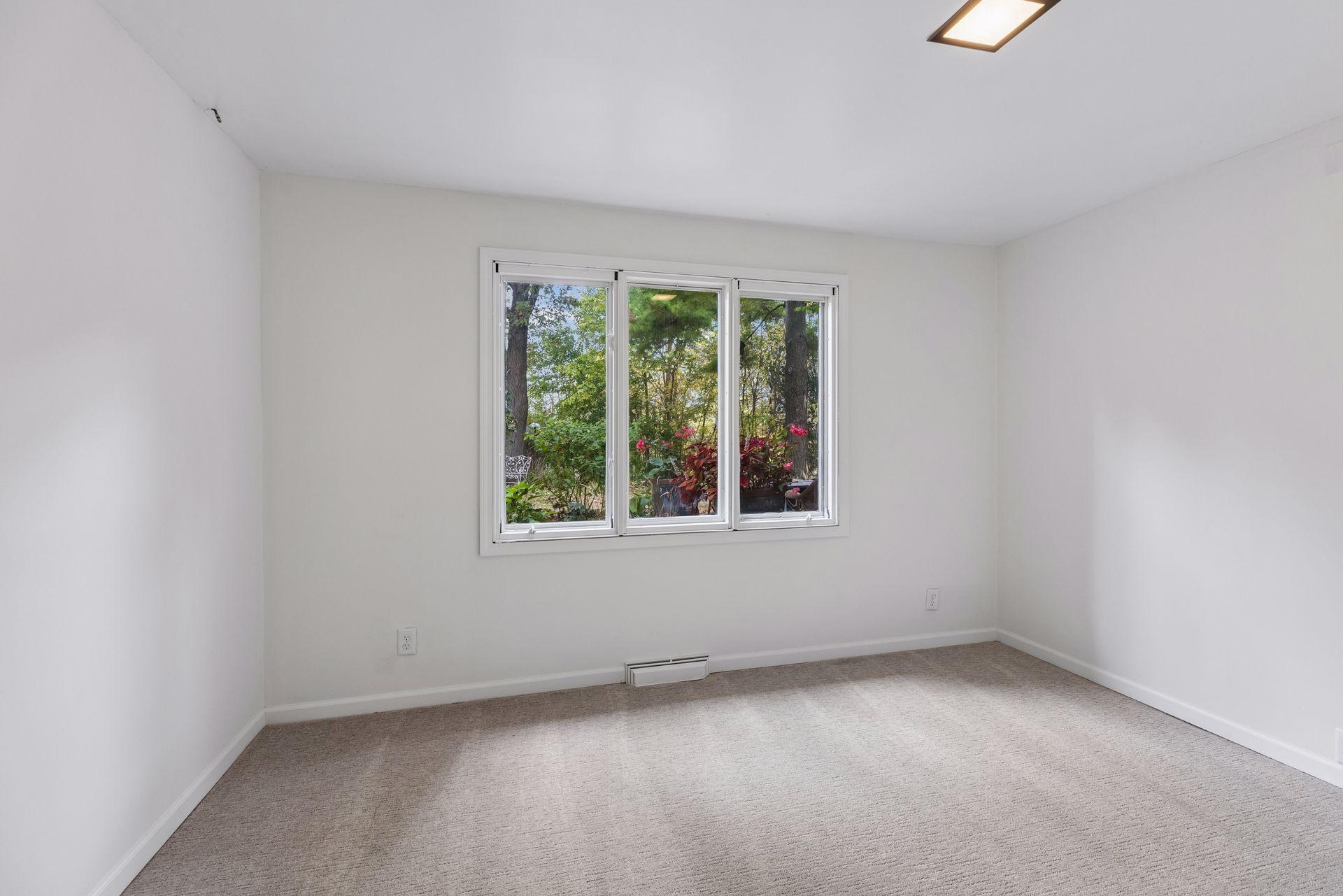 Bedroom 3 in lower level, freshly painted with new carpet