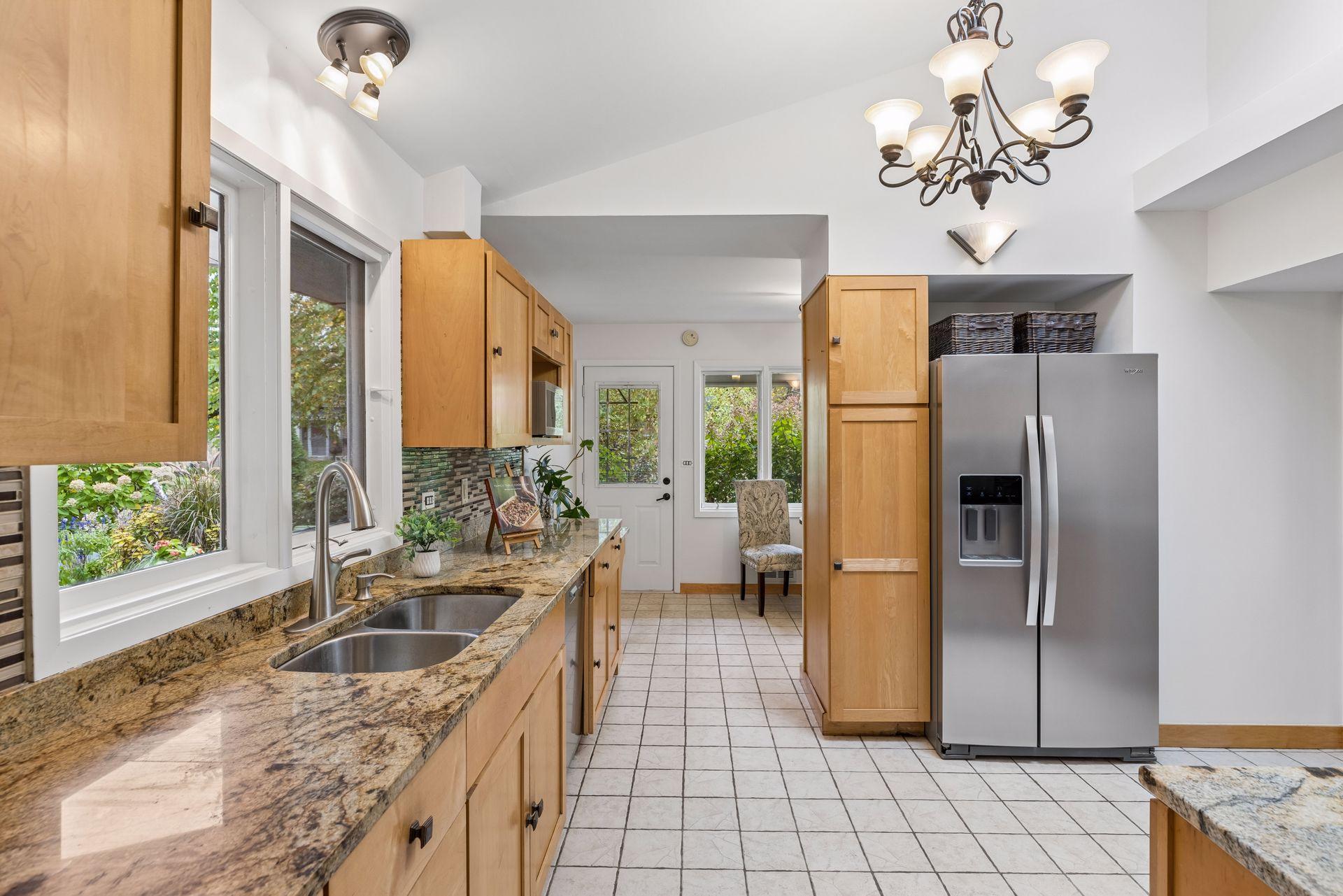 Large kitchen windows above sink offer a beautiful courtyard view