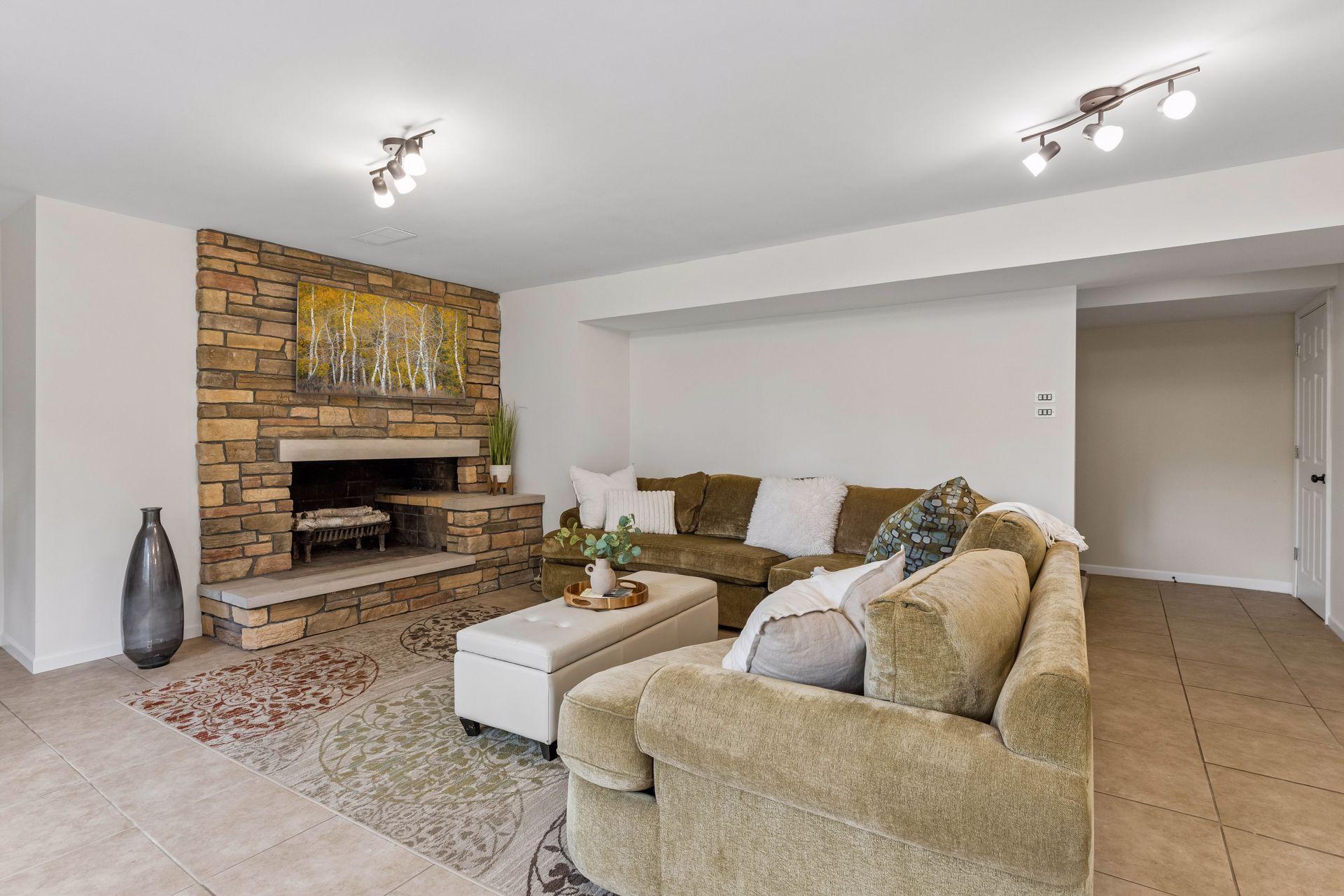 Stone wood burning fireplace in lower level family room