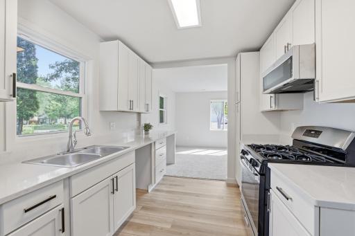 BRAND NEW kitchen with quartz countertops, designer hardware and stainless-steel appliances.