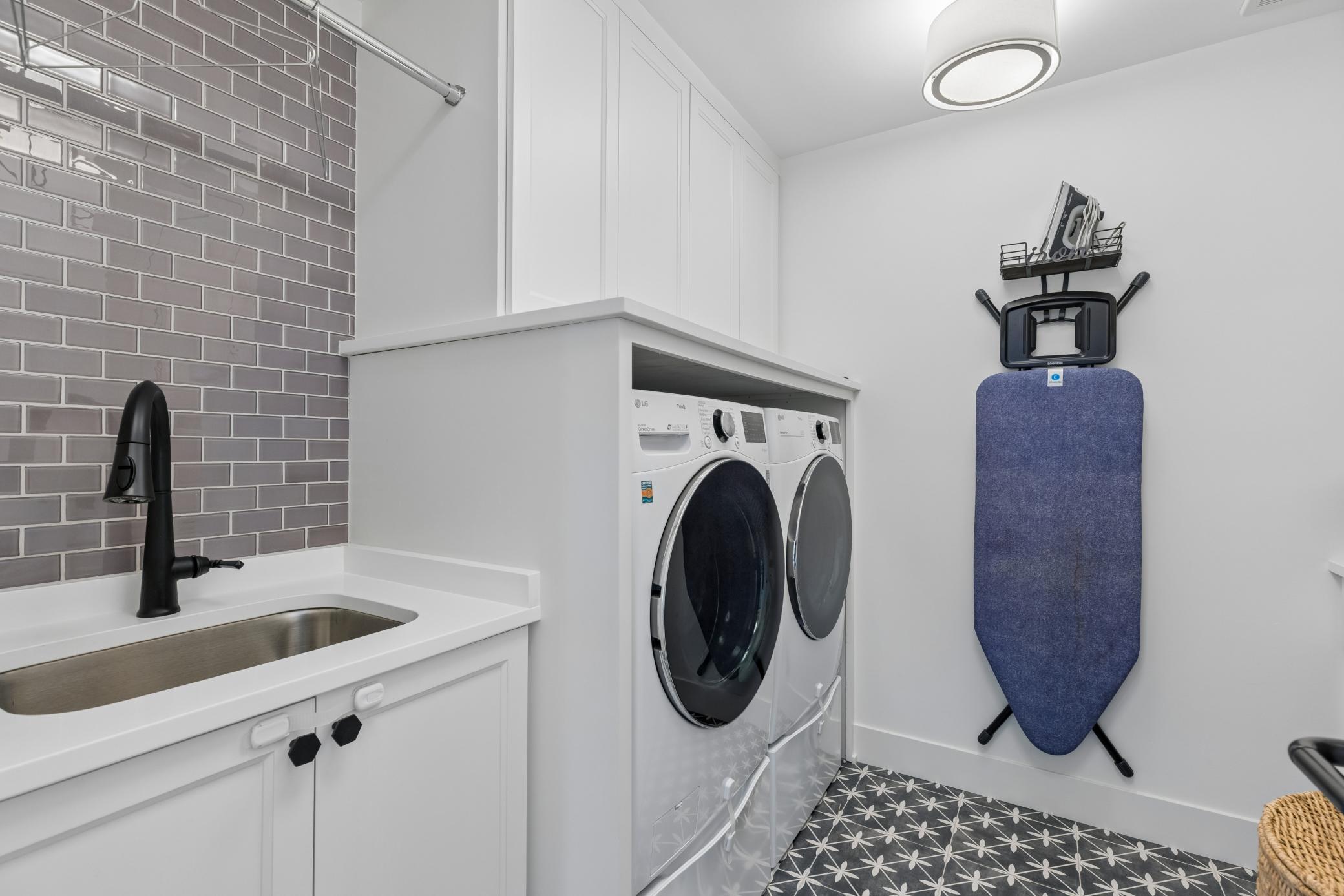 Convenient upper-level laundry room with built-in storage.