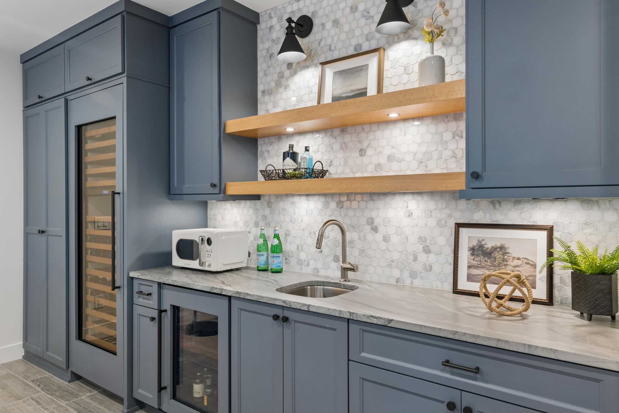 Well-appointed wet bar with wine cooler, beverage fridge & custom cabinetry.