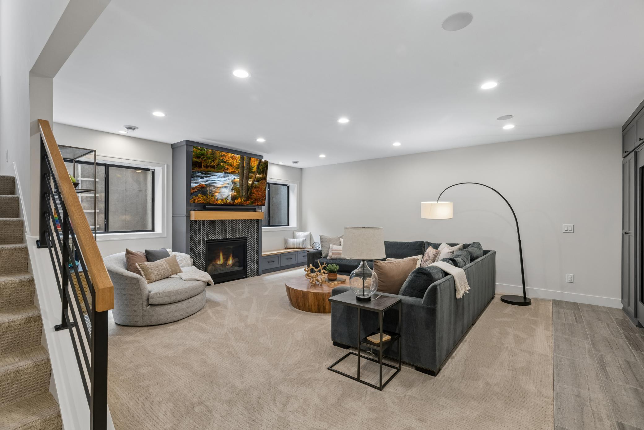 Warm lower-level family room with fireplace & built-ins