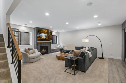 Warm lower-level family room with fireplace & built-ins