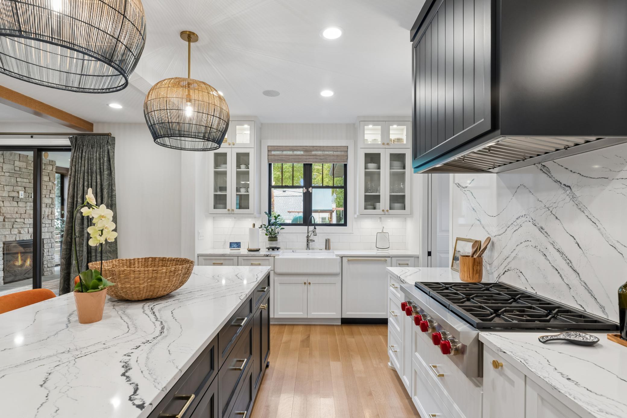 Wolf cooktop with custom hood & quartz backsplash.