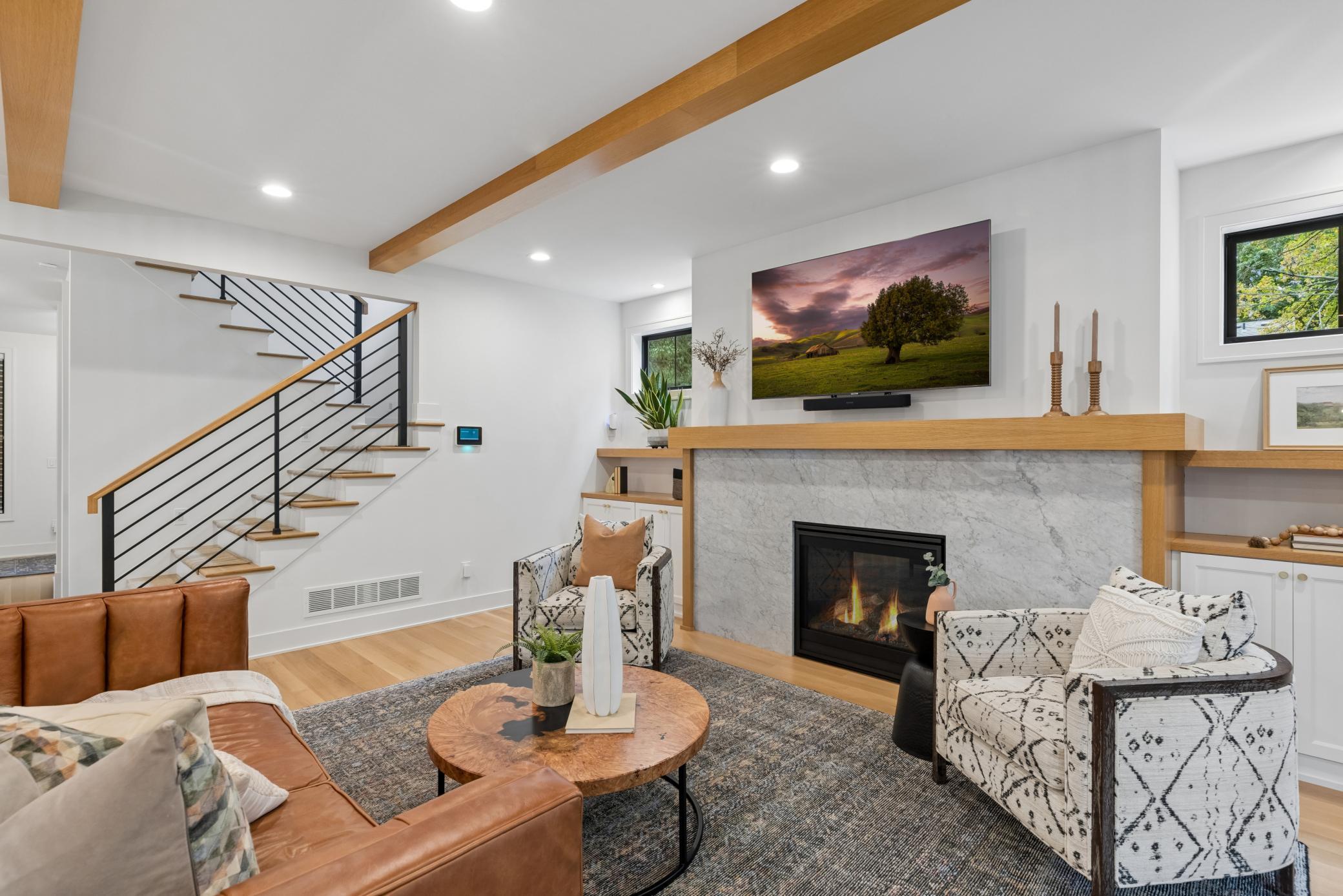 Warm living room with fireplace & built-in cabinetry.