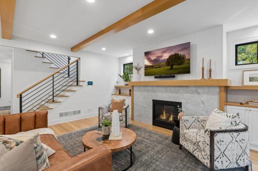 Warm living room with fireplace & built-in cabinetry.
