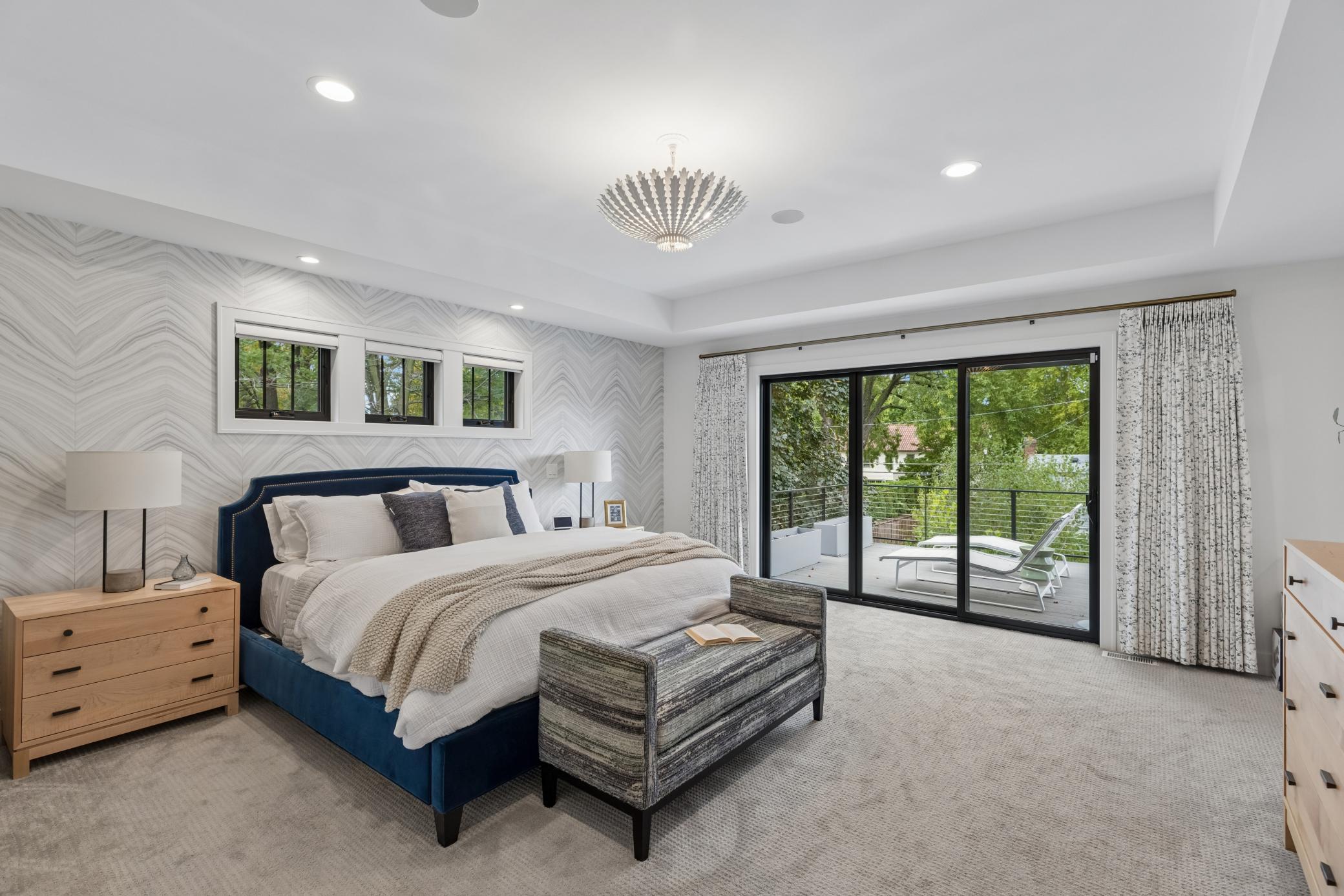 Spacious primary bedroom with private balcony overlooking the backyard.