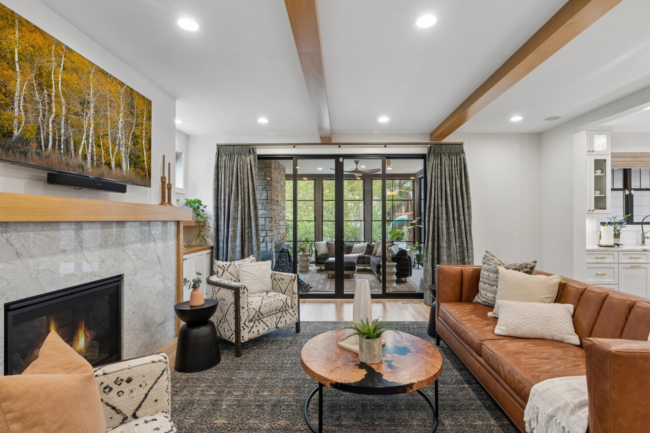 Living room flows seamlessly to the screened porch.
