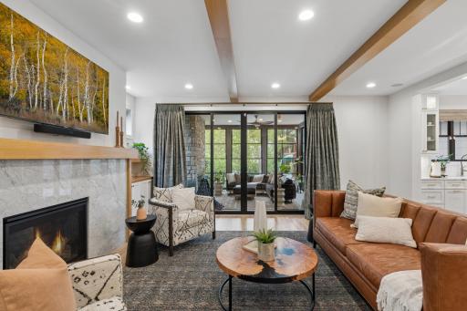Living room flows seamlessly to the screened porch.