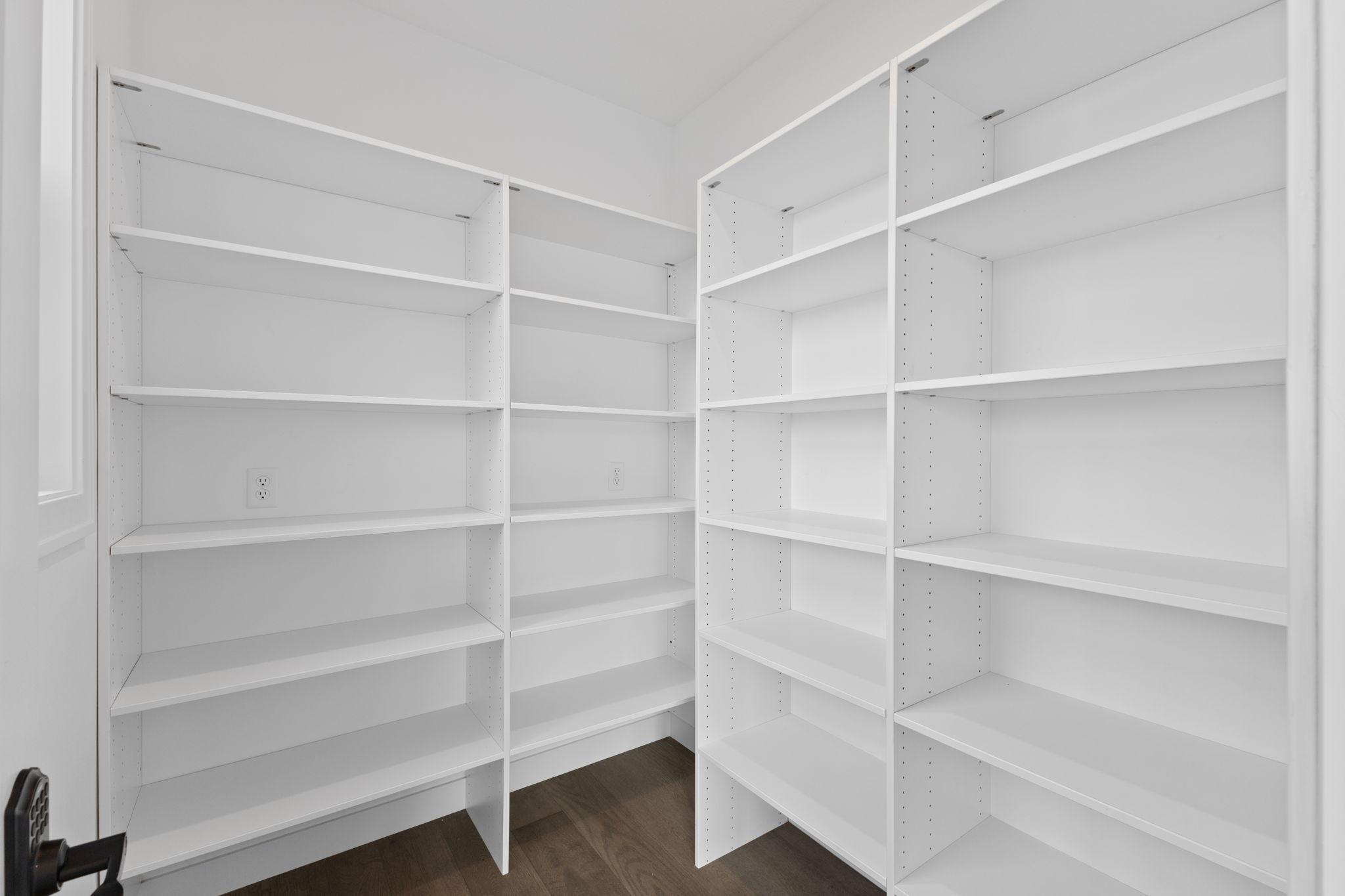 This incredible walk-in pantry offers an abundance of shelving and storage space.