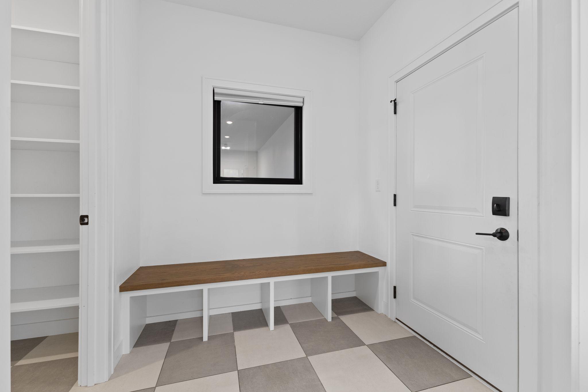 The mudroom features built-in bench seating and cubbies to help keep everyday items organized.
