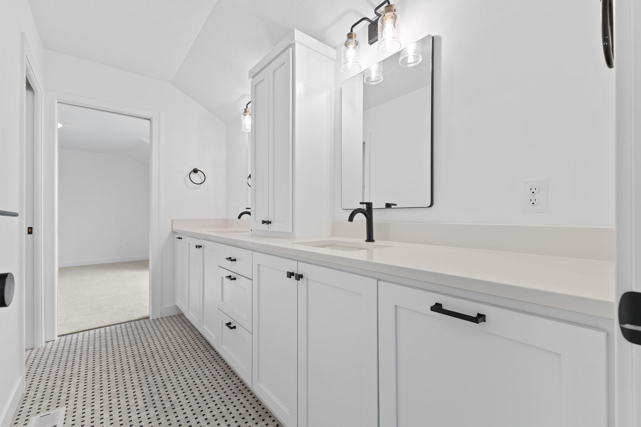 Dual vanities provide plenty of space to share in the Jack-and-Jill bath.