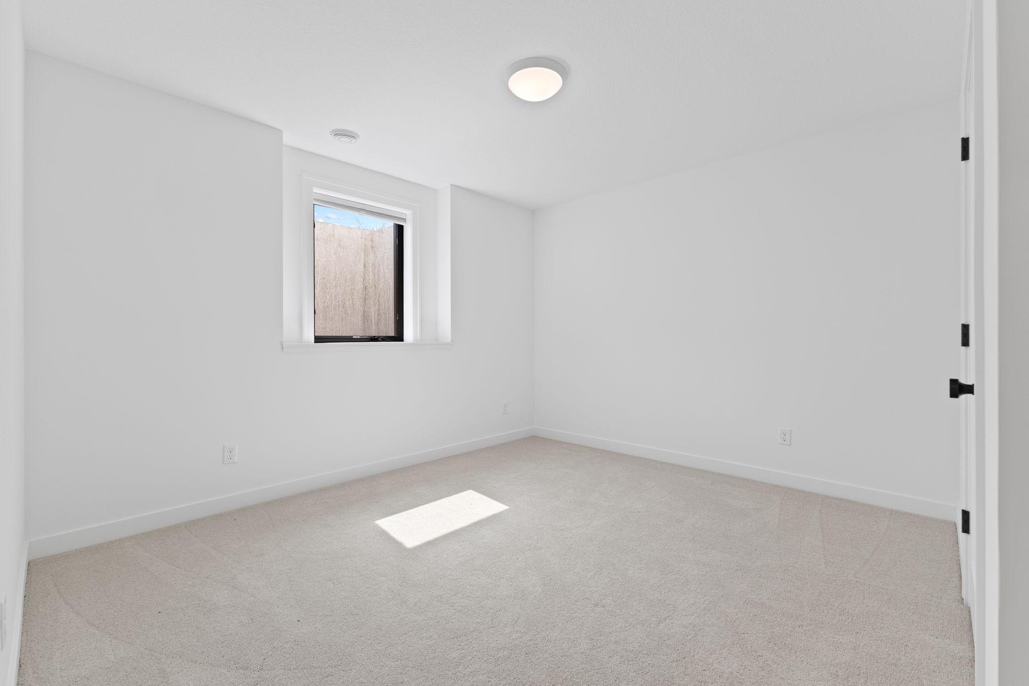 An additional lower-level bedroom provides comfortable space for guests or family.
