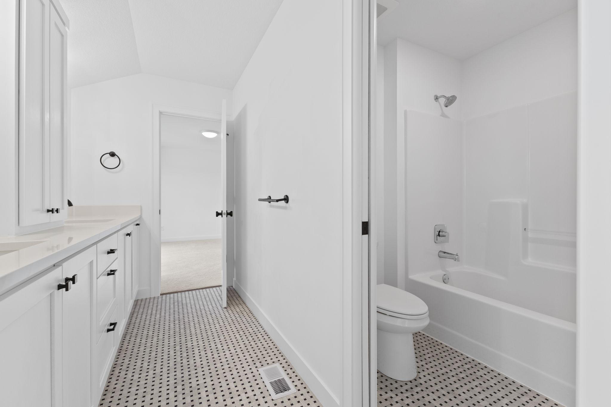 A separate tub and toilet area adds functionality to the shared bathroom layout.