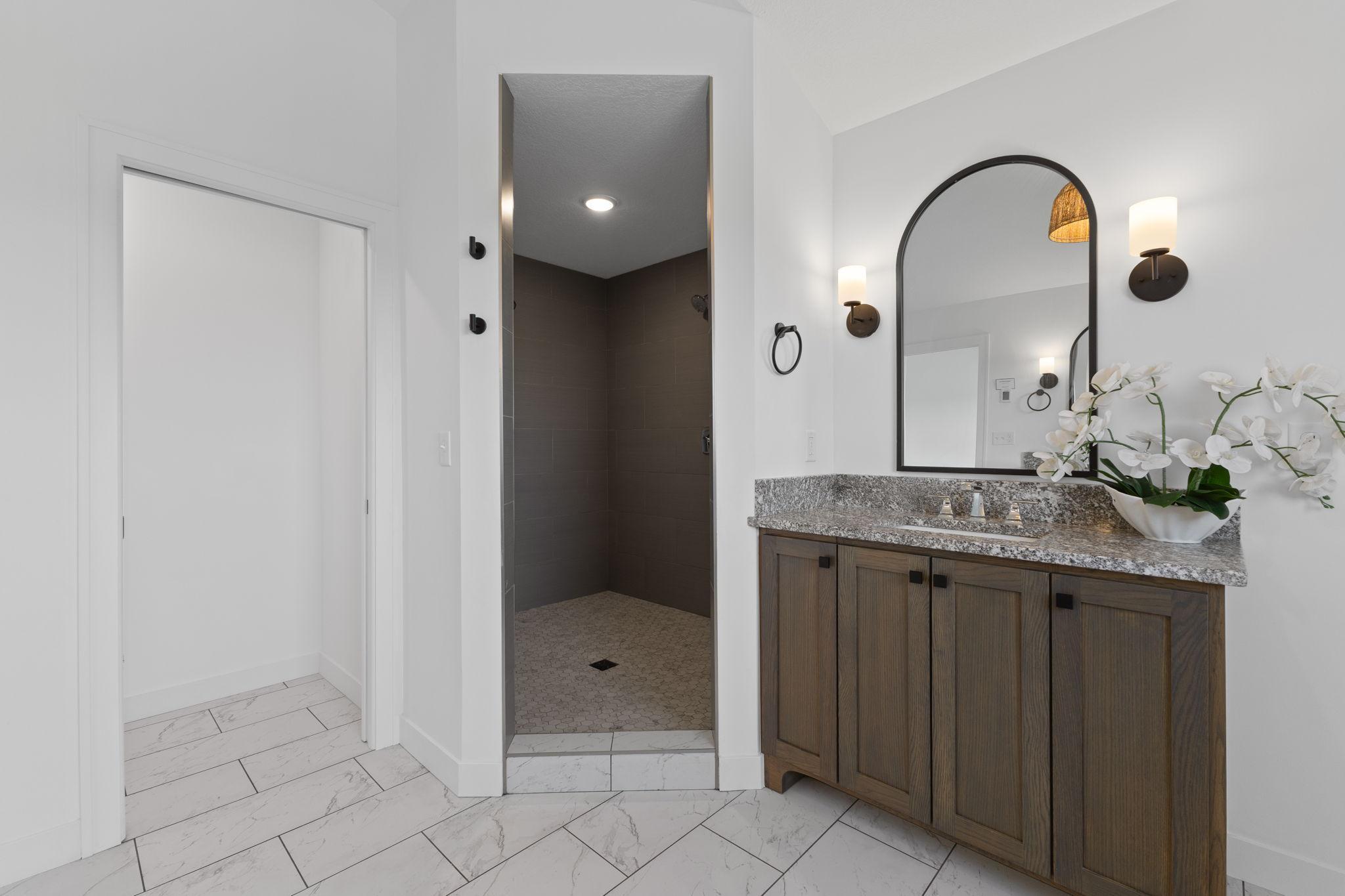 Custom tile and an oversized walk-in shower elevate the primary suite even further.