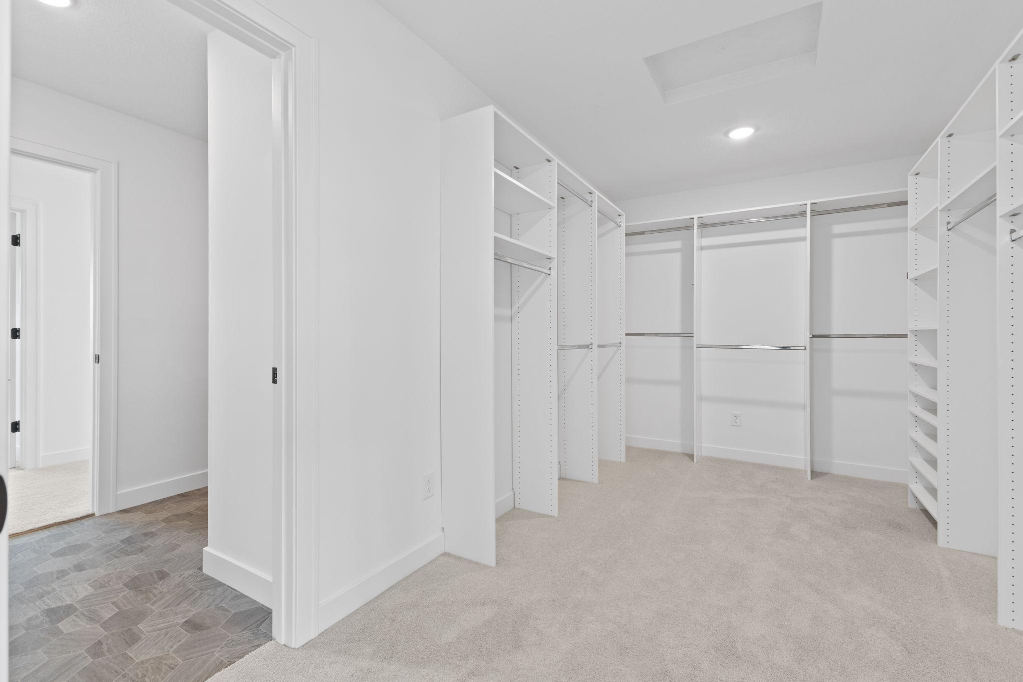 An expansive primary walk-in closet provides exceptional built-in storage and organization.
