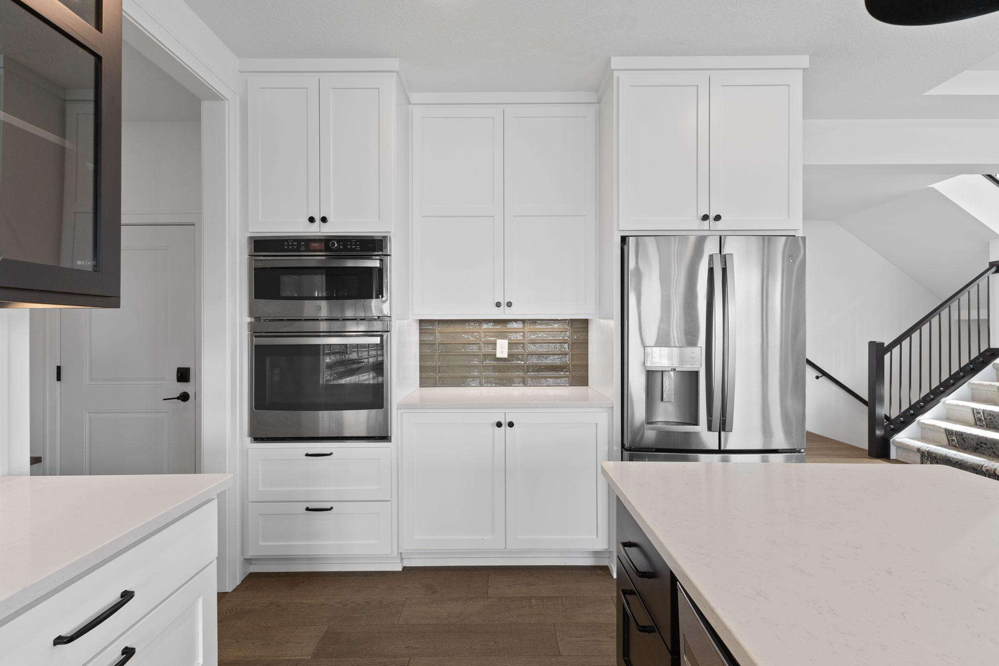 Built-in appliances are surrounded by an abundance of cabinetry for additional kitchen storage.