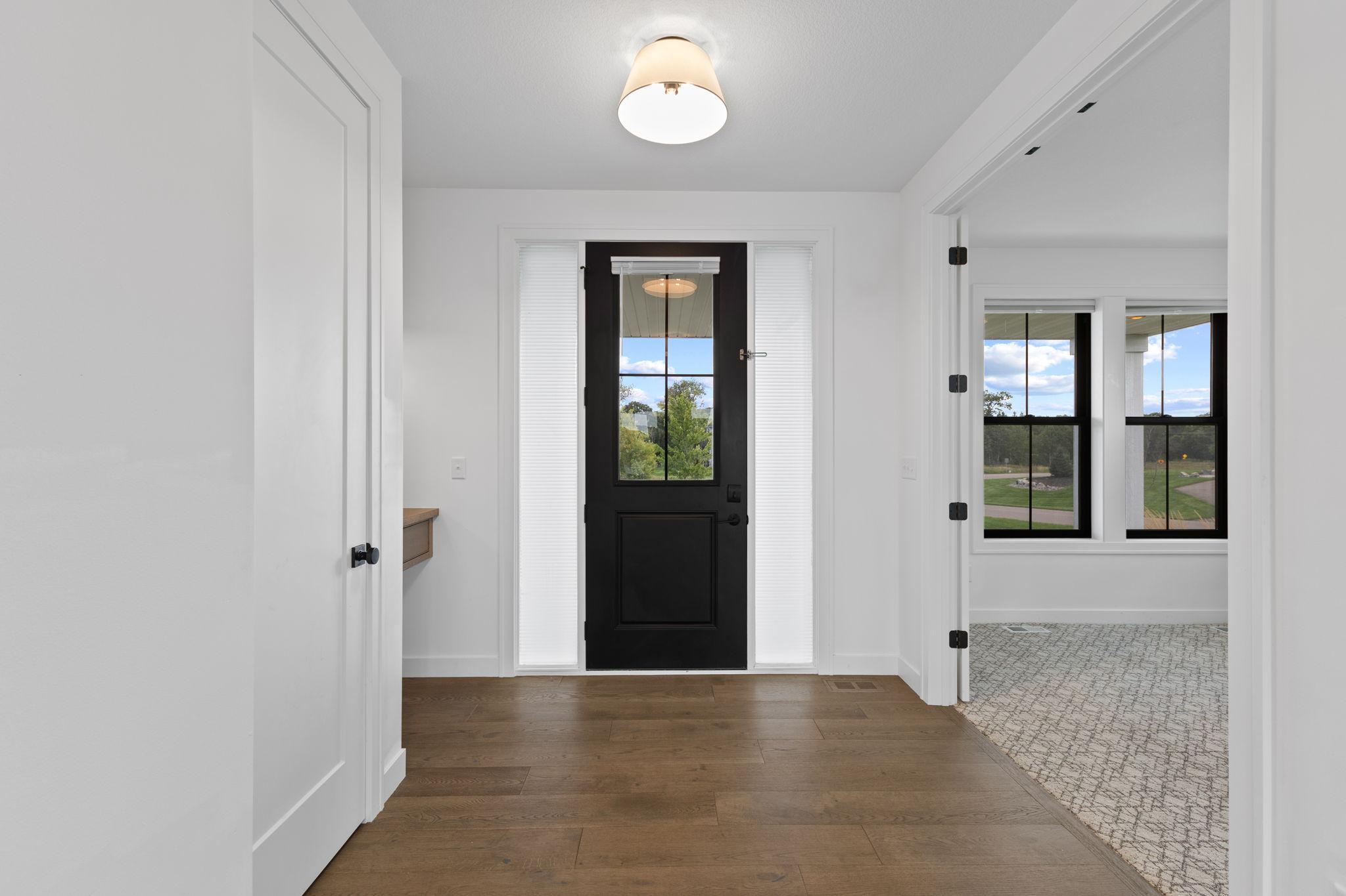 Step inside to a bright, welcoming entry with beautiful wood flooring.
