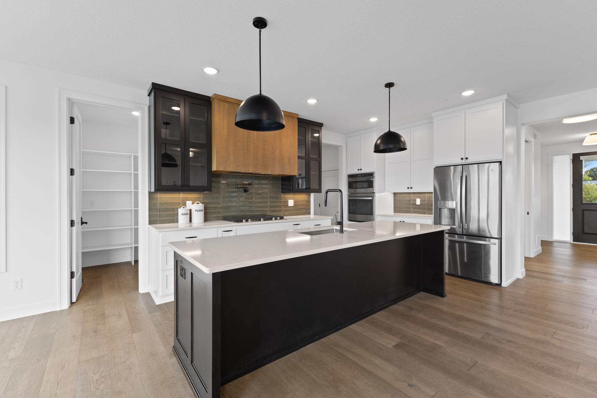 Custom cabinetry, high-end appliances and generous workspace make this kitchen both beautiful and functional.