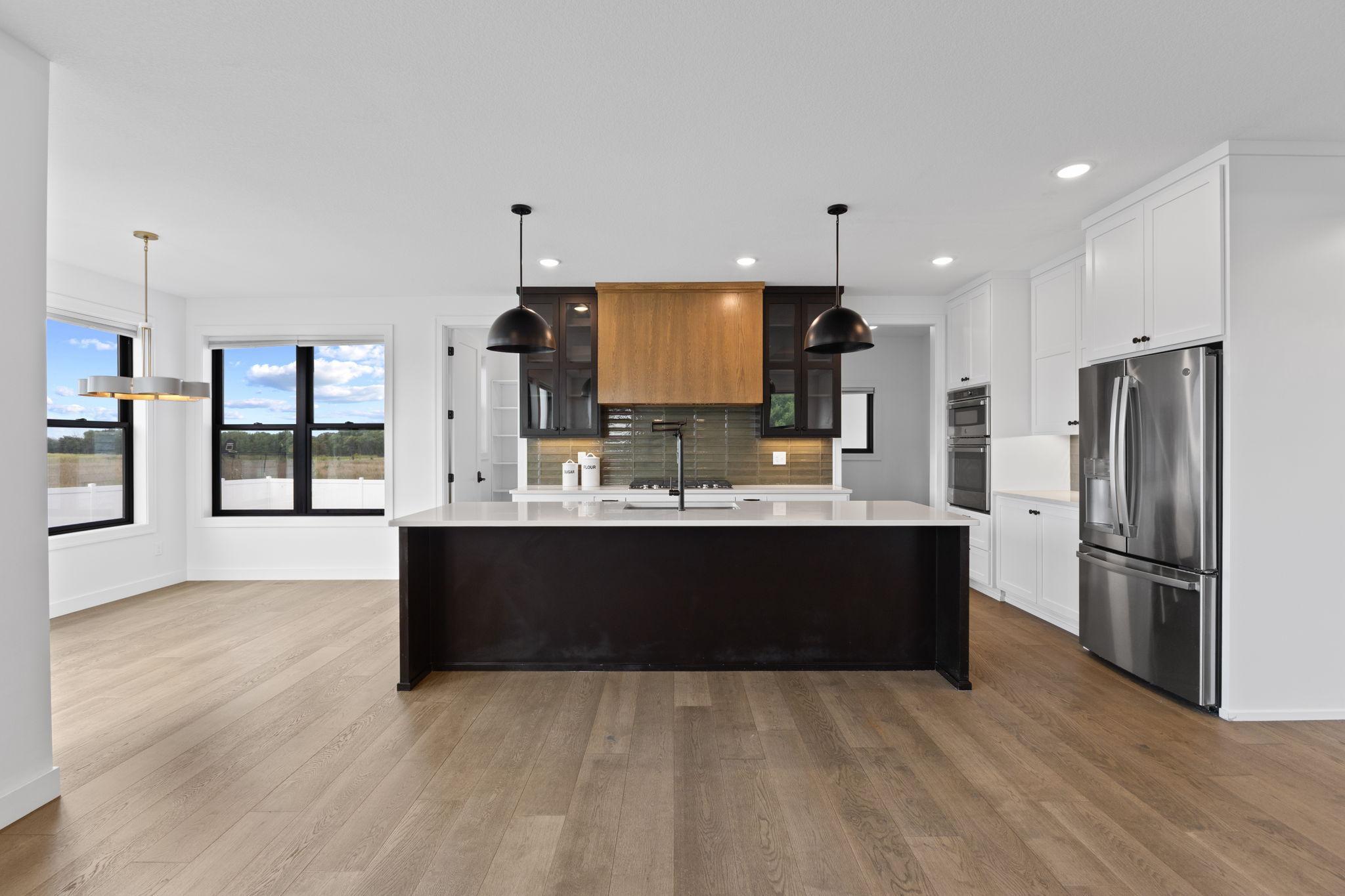 At the heart of the home, the gourmet kitchen offers an oversized island with plenty of room to gather.